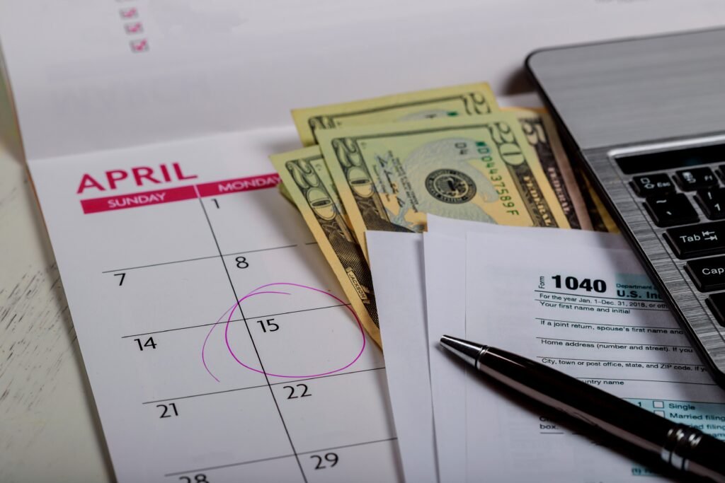1040 US Tax Form with Deadline Calendar and Dollar Bills